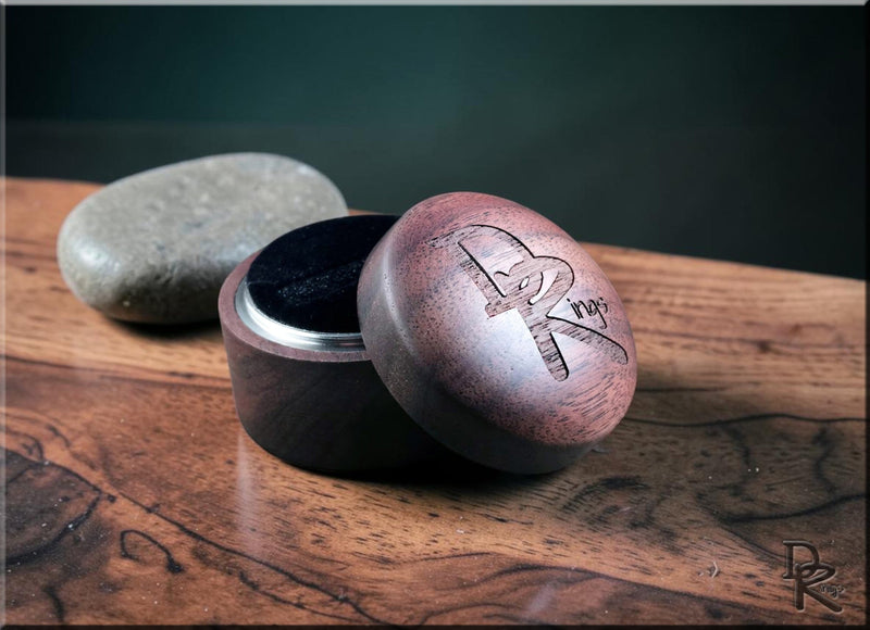 High quality wooden ring boxes and sizers displayed on a polished wooden surface