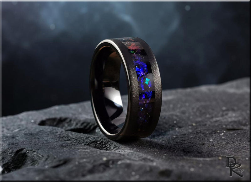 Black ring with colorful inlay on dark textured surface from quick ship rings collection