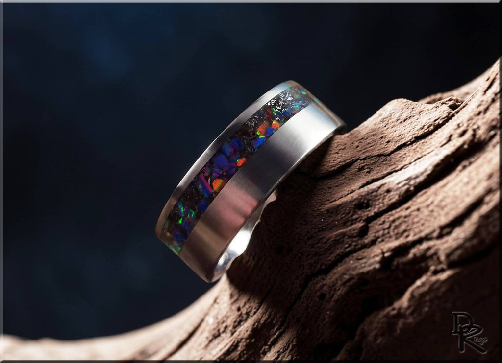 DR Rings titanium ring with meteorite inlay featuring colorful opal accents on textured surface