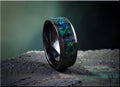 DR Rings ceramic ring with black band and iridescent blue green inlay on textured surface