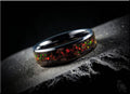 DR Rings ceramic ring with inlay featuring a glossy black band and vibrant red and green embedded pieces