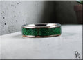 Damascus steel ring with malachite featuring a green stone inlay and textured metal edges