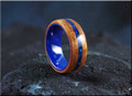 Koa wood ring with opal and ceramic blue inlay by DR Rings on black textured surface