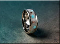 DR Rings titanium ring with inlay featuring turquoise and brown accents on a dark background