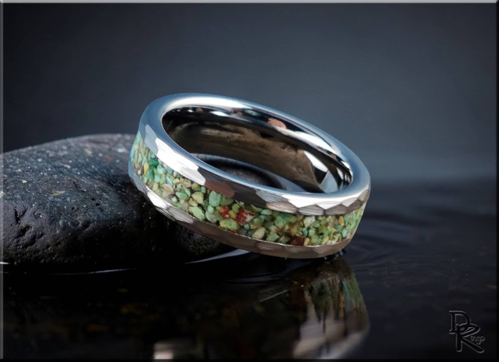 DR Rings tungsten as a ring with green stone inlay and polished silver finish on dark surface