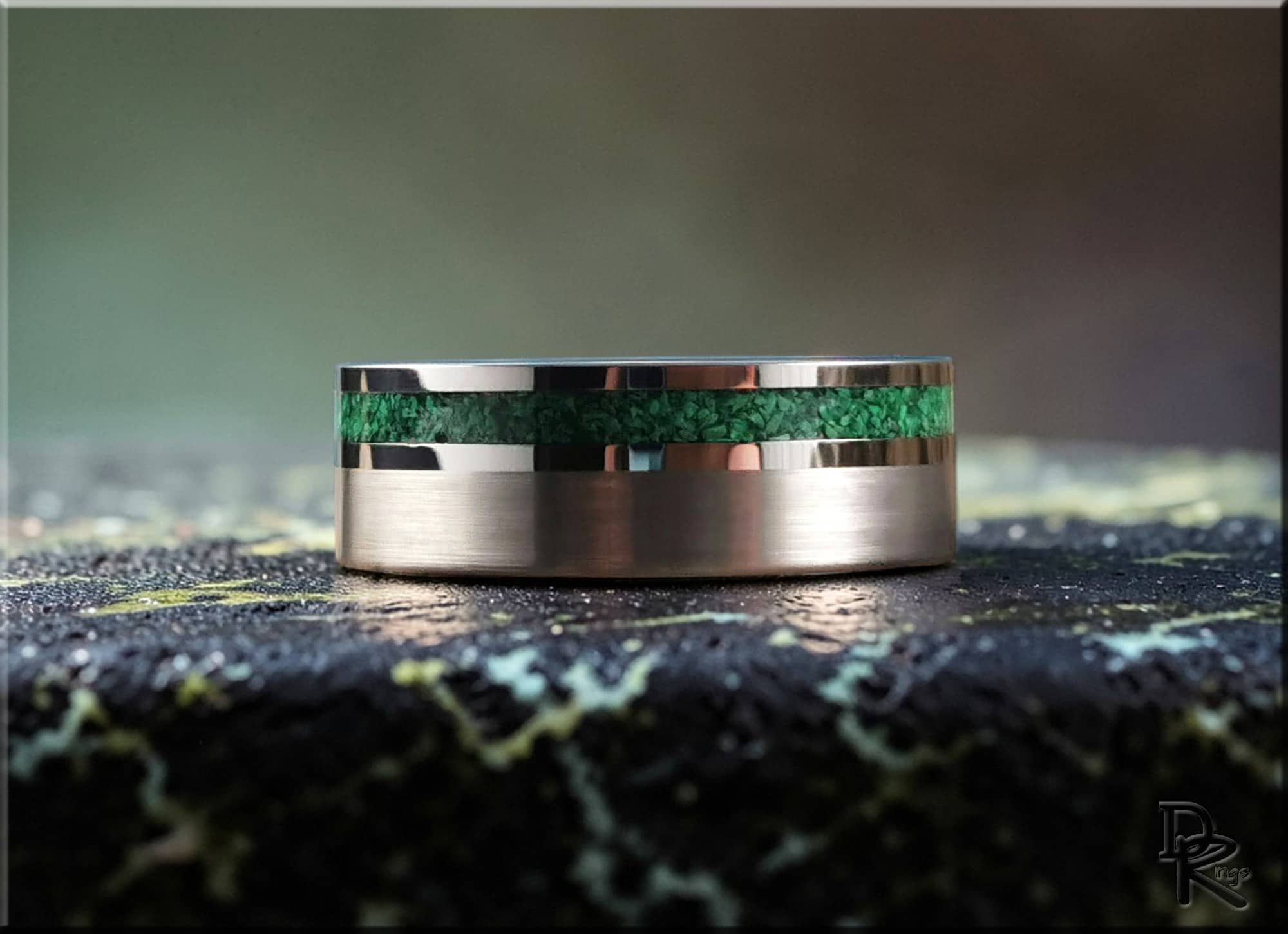 DR Rings tungsten ring carbide with green inlay on textured surface background