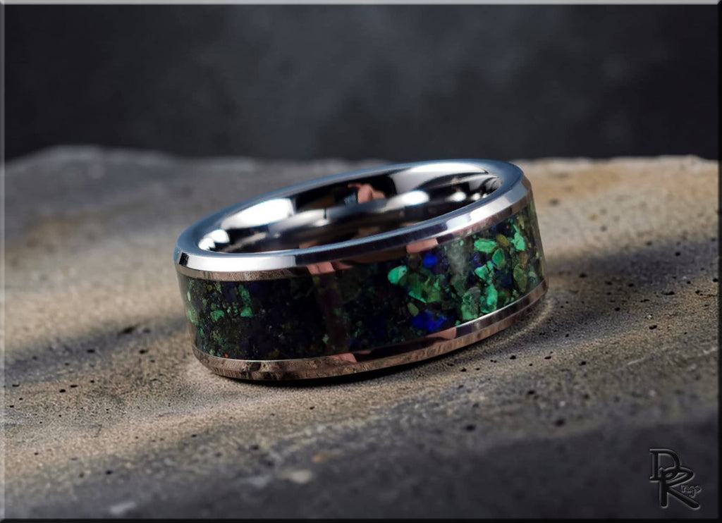Tungsten ring carbide with green and blue gemstone inlay by DR Rings on textured surface