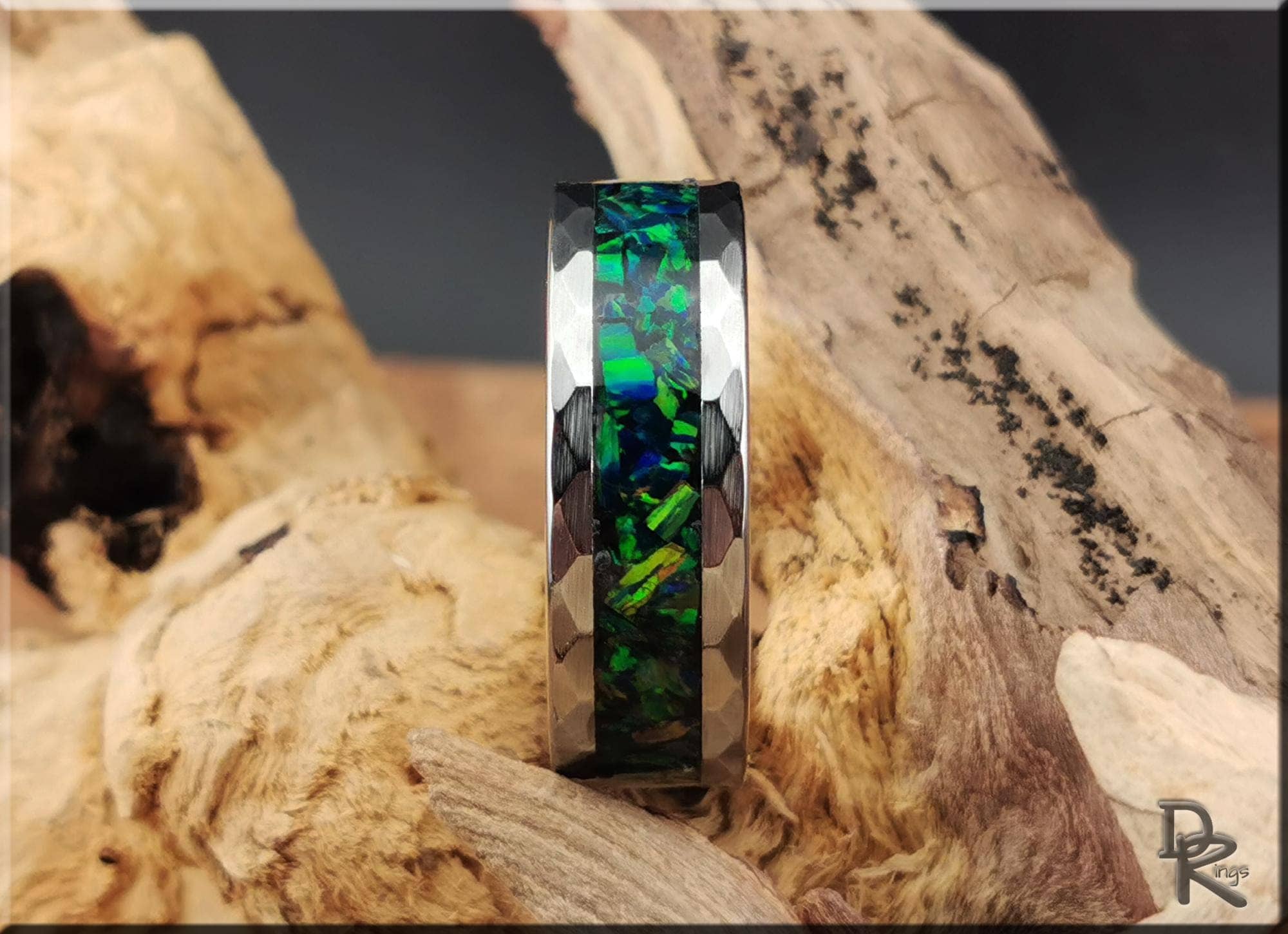 DR Rings tungsten ring with green opal channel in polished silver tone on rustic wood background