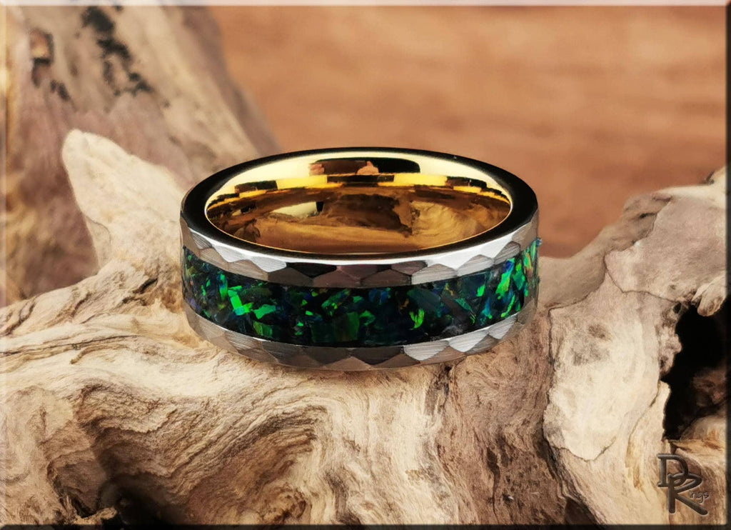 DR Rings tungsten ring with green opal inlay and gold interior on natural wood background