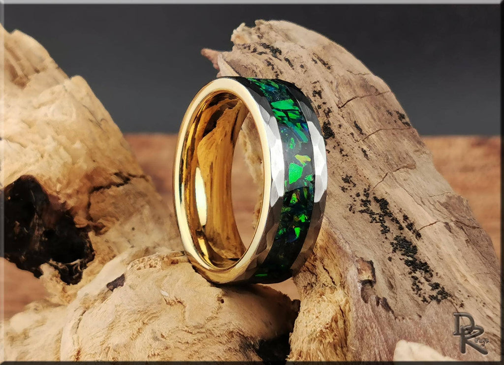 DR Rings tungsten ring with green opal inlay and gold interior, displayed on rustic wood background