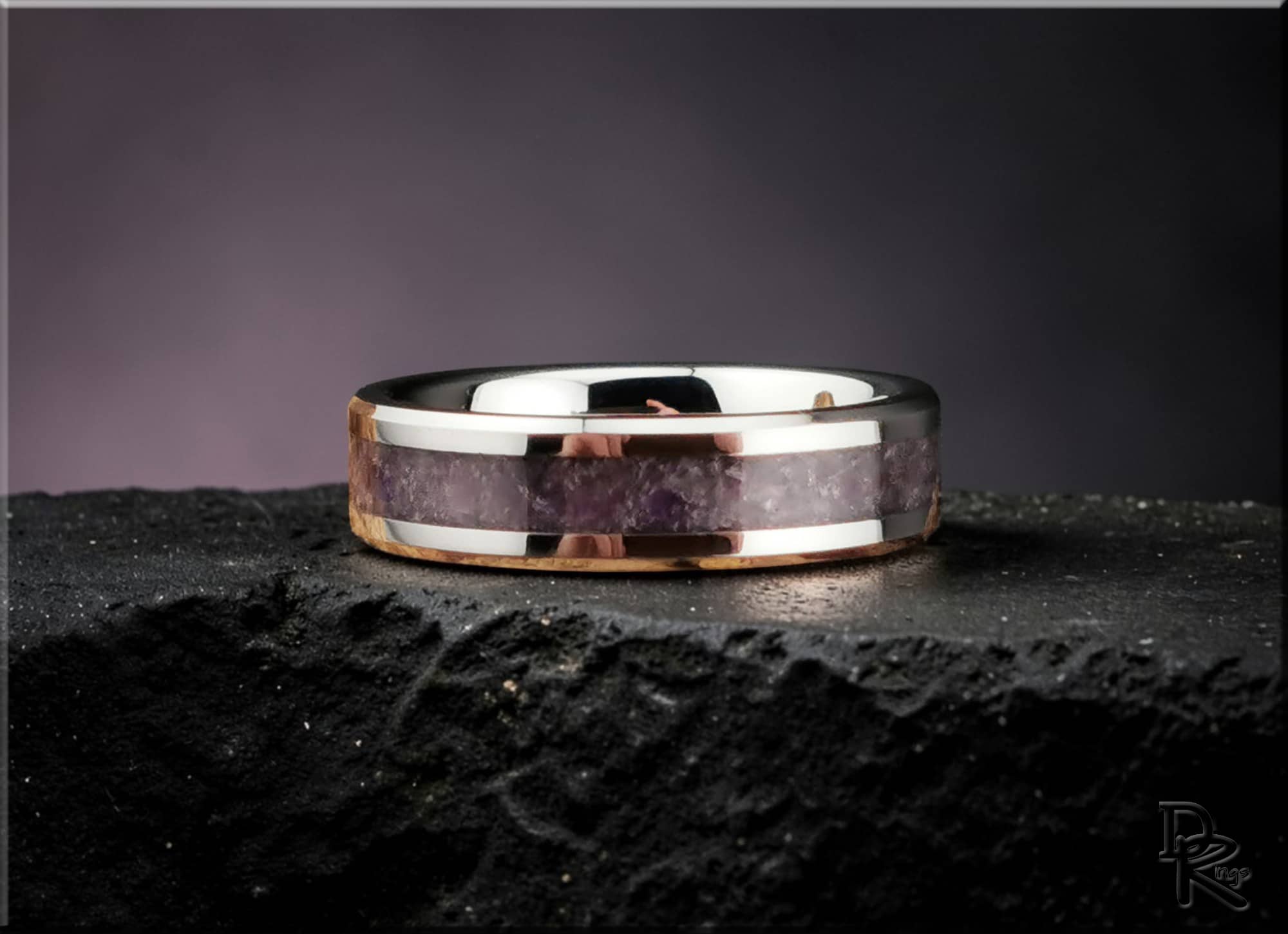 DR Rings tungsten ring with amethyst inlay featuring polished silver edges on textured black surface