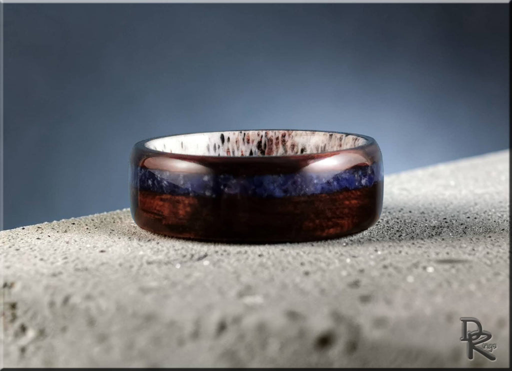 DR Rings elegant wood ring with inlay featuring dark brown and blue tones on textured surface