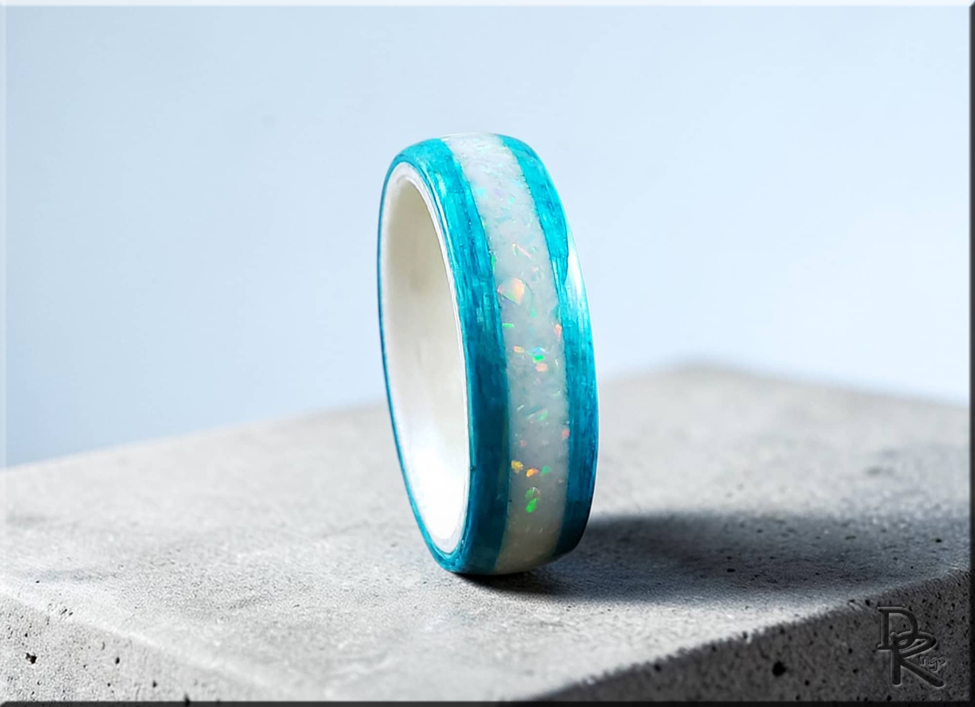 DR Rings wood ring with opal inlay featuring turquoise blue wood and glowing opal center band