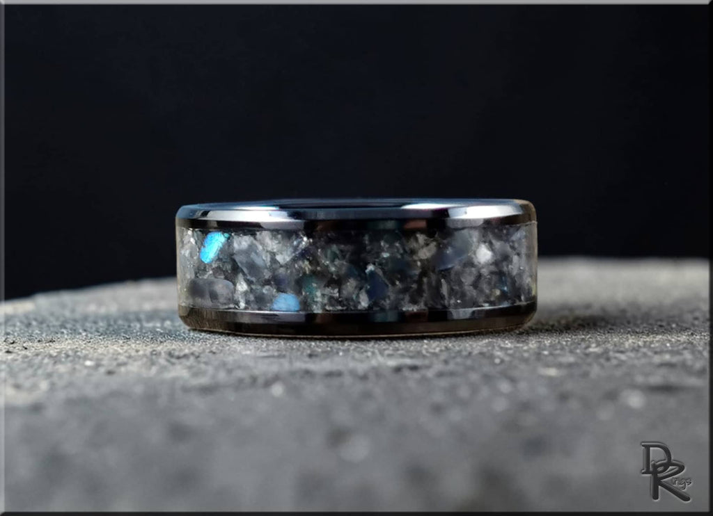 DR Rings black ceramic ring with inlay featuring a textured stone-like design on a dark surface