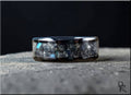 DR Rings black ceramic ring with inlay featuring a textured stone-like design on a dark surface