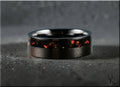 DR Rings black band ring opal inlay with vibrant red and orange flecks on dark textured surface