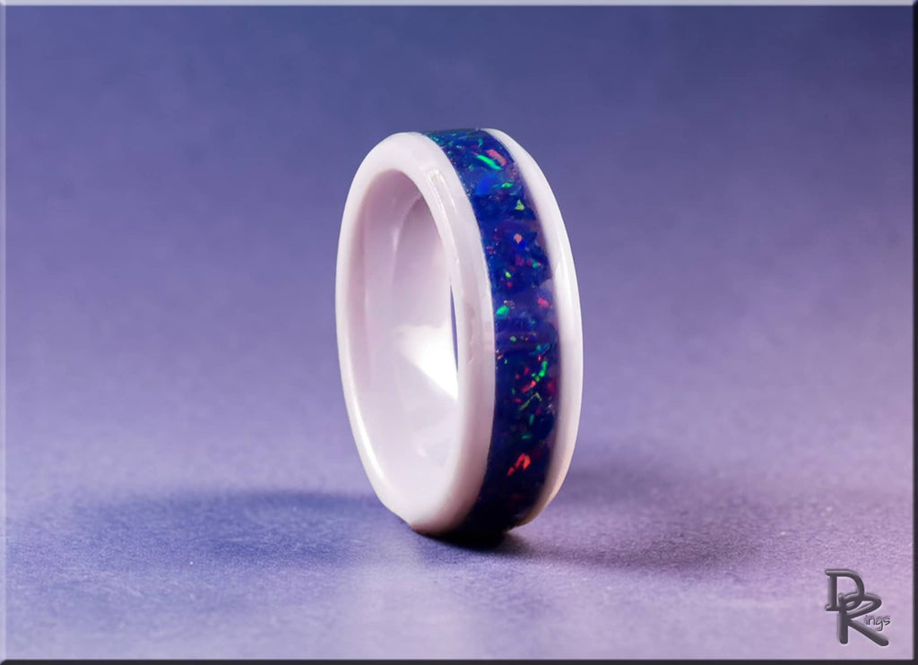 DR Rings white ceramic ring with opal inlay featuring vibrant blue and multicolor sparks