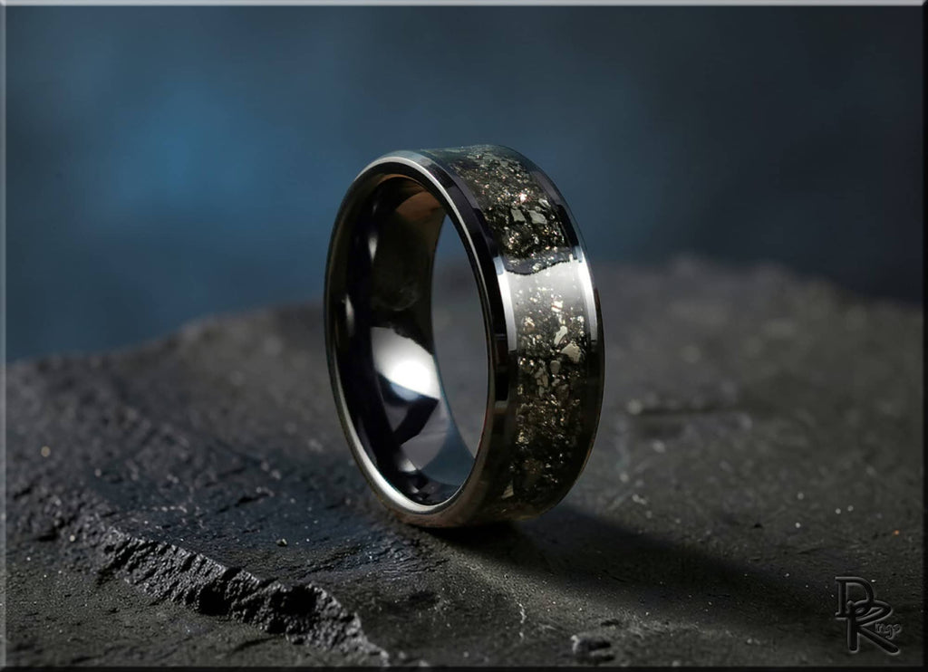 DR Rings ceramic ring with pyrite inlay on dark textured surface with reflective black finish