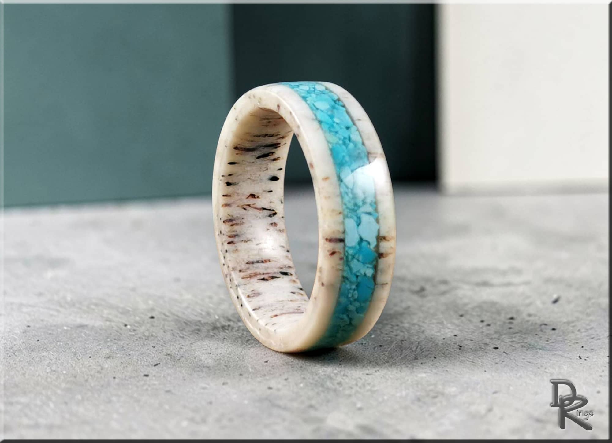 Deer antler ring with turquoise inlay showcasing natural texture and vibrant blue stone detailing
