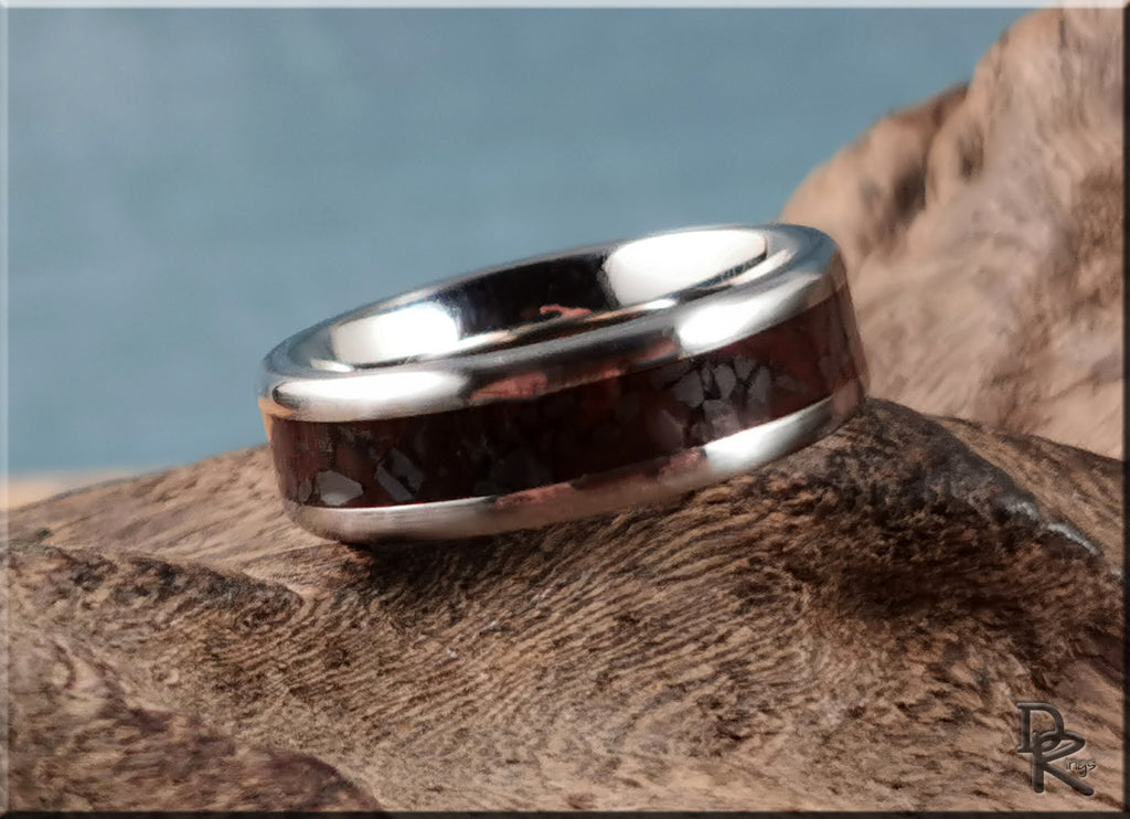DR Rings titanium smart ring with dark inlay on textured wooden surface