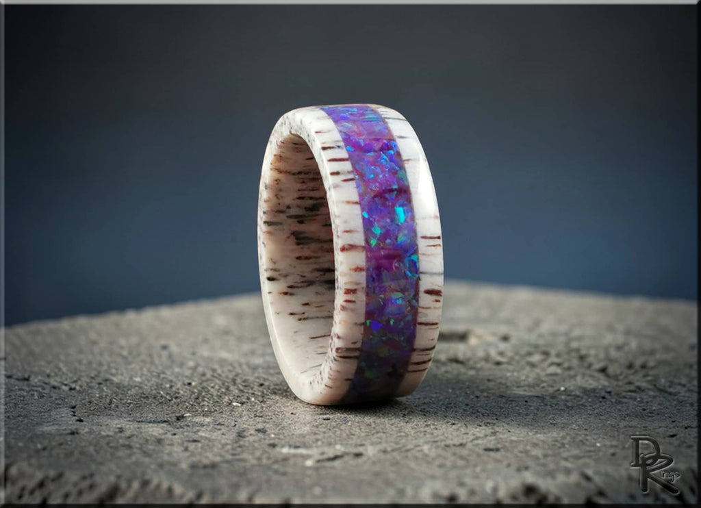 Deer antler ring with opal inlay featuring vibrant purple and blue opal colors and natural antler texture