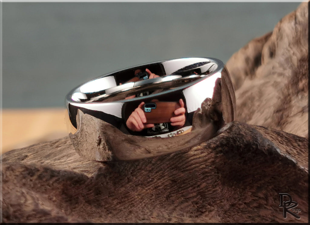 Shiny domed cobalt ring by DR Rings resting on textured brown surface with high polish finish