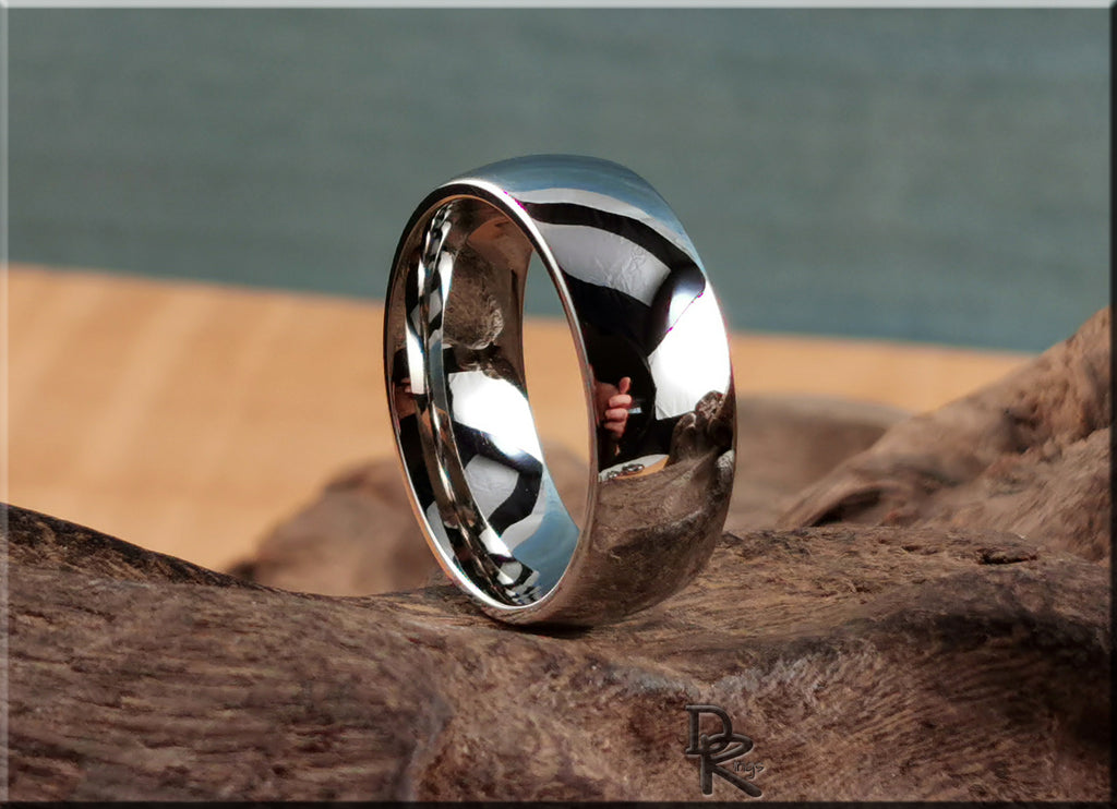 Domed cobalt ring with polished finish displayed on textured wooden surface by DR Rings