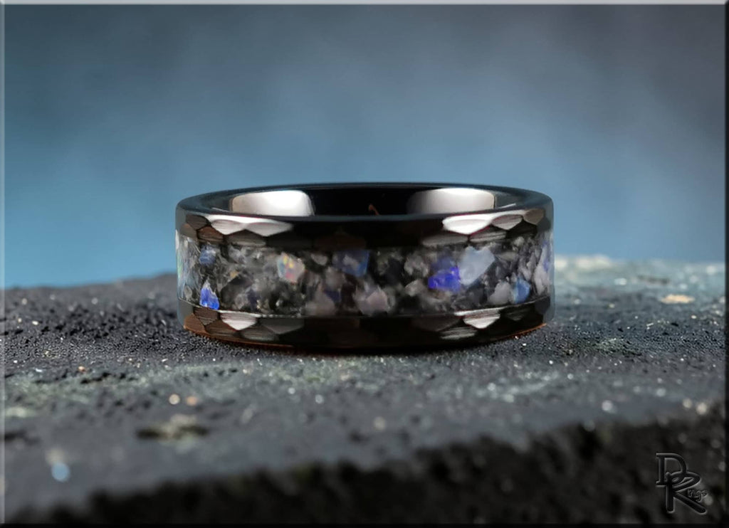 Hammered ceramic ring with inlay featuring a polished black band and blue stone accents by DR Rings