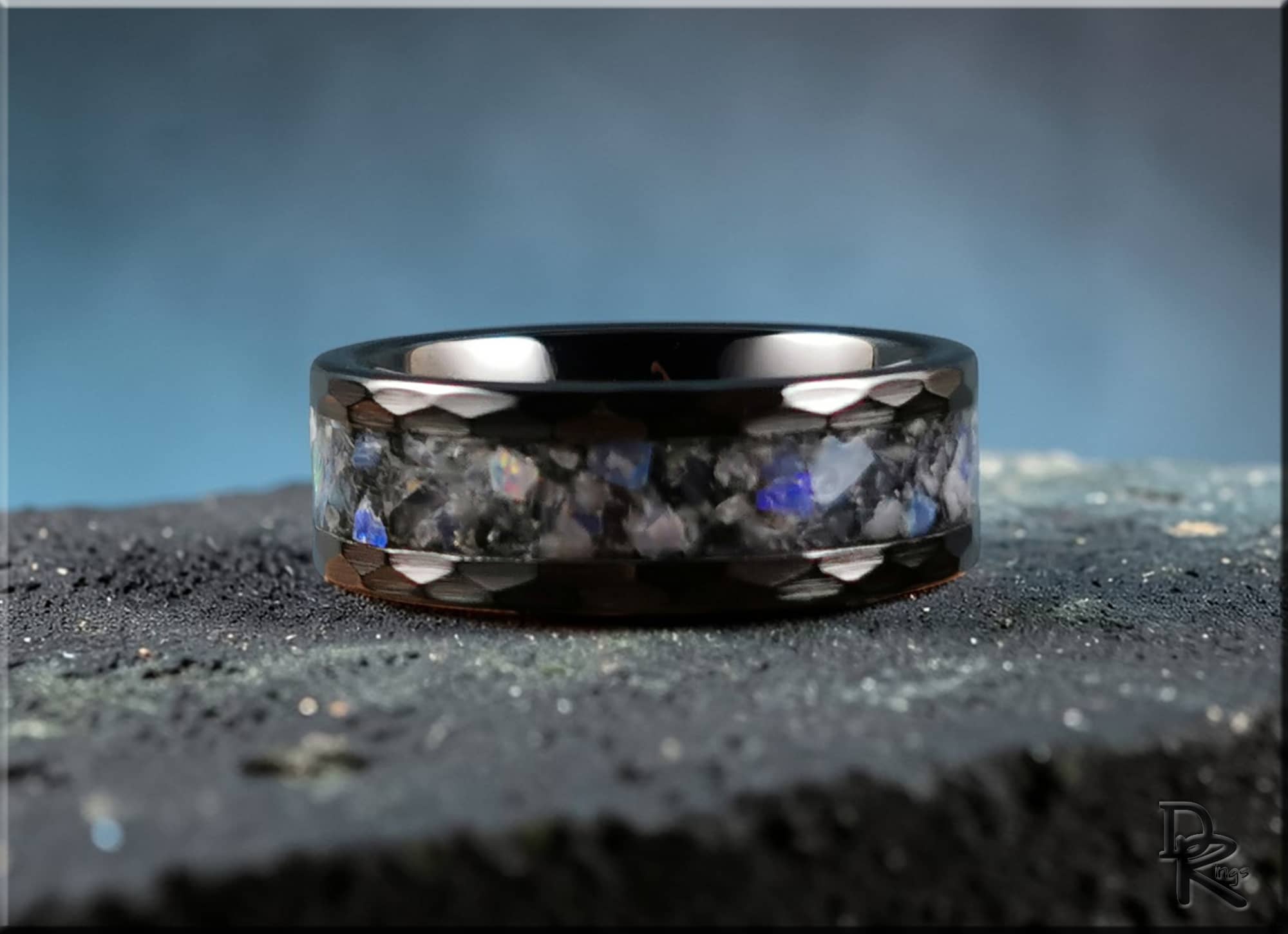 Hammered ceramic ring with inlay featuring a polished black band and blue stone accents by DR Rings