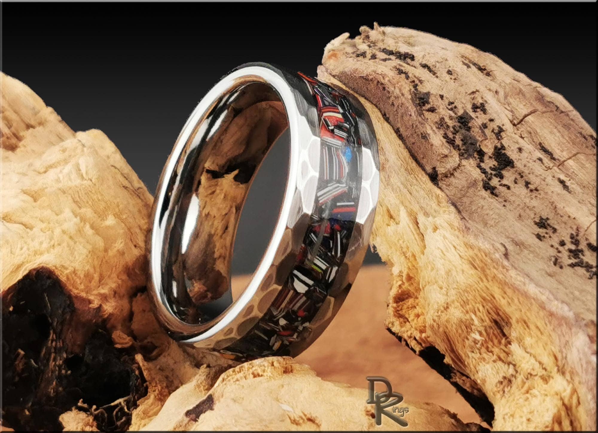 DR Rings tungsten as a ring with a polished silver edge and black carbon fiber inlay on natural wood