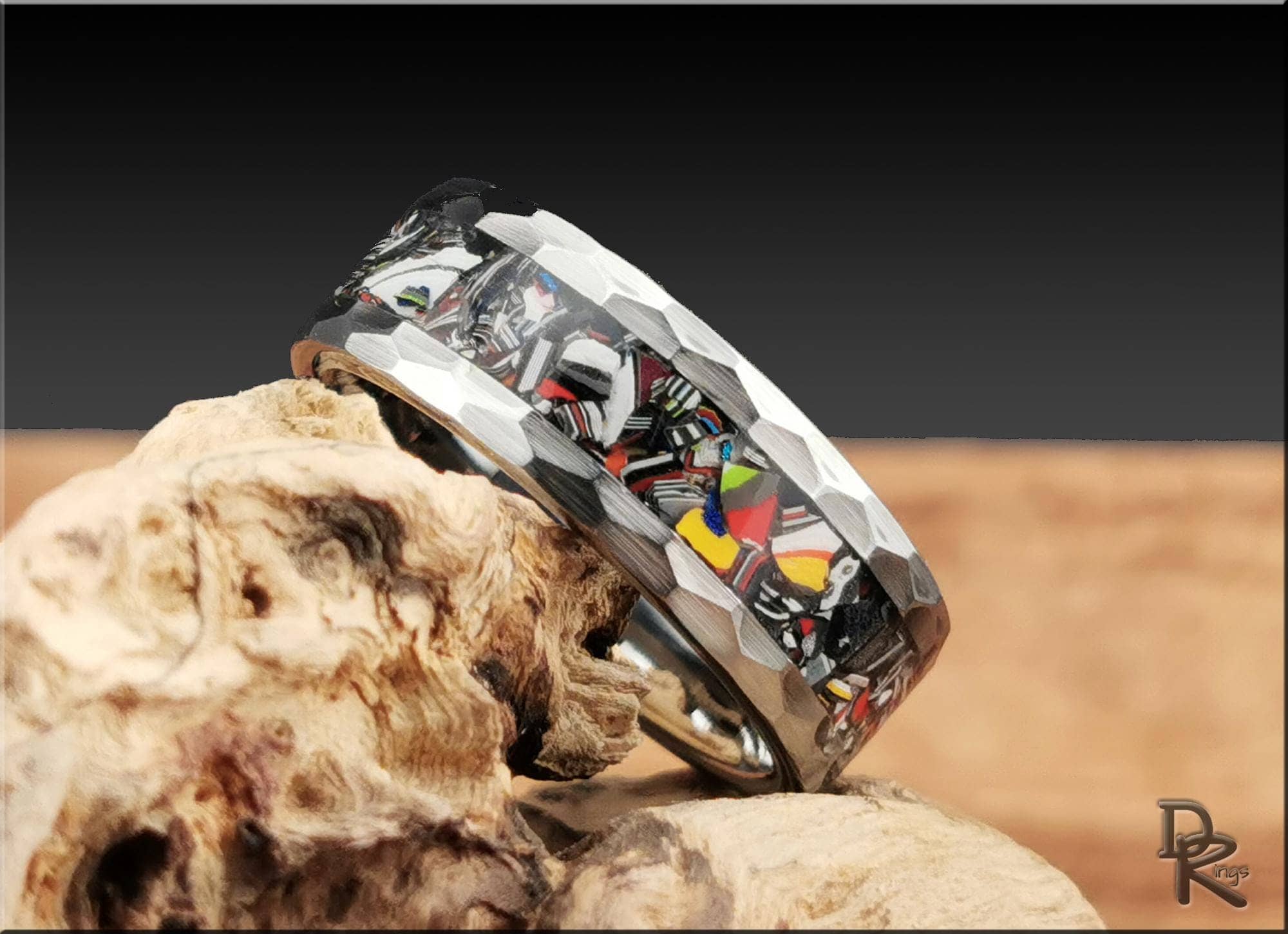 DR Rings unique handcrafted tungsten as a ring with colorful inlay and faceted edges on natural wood
