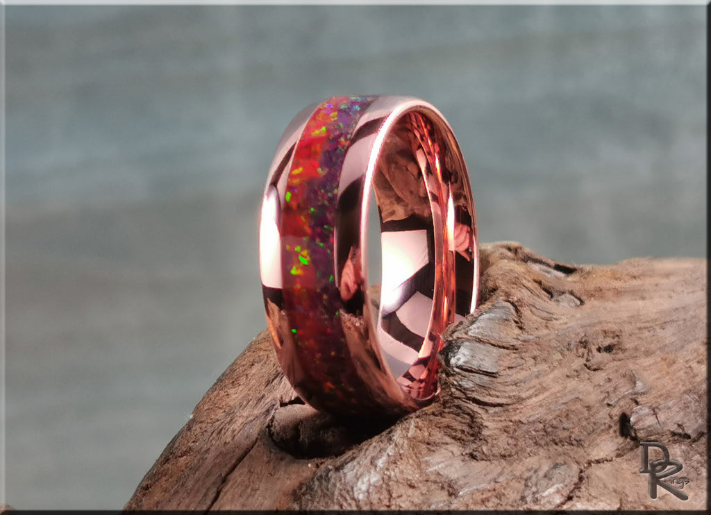 Brushed tellurium copper ring with opal inlay showing vibrant colors on rustic wood background