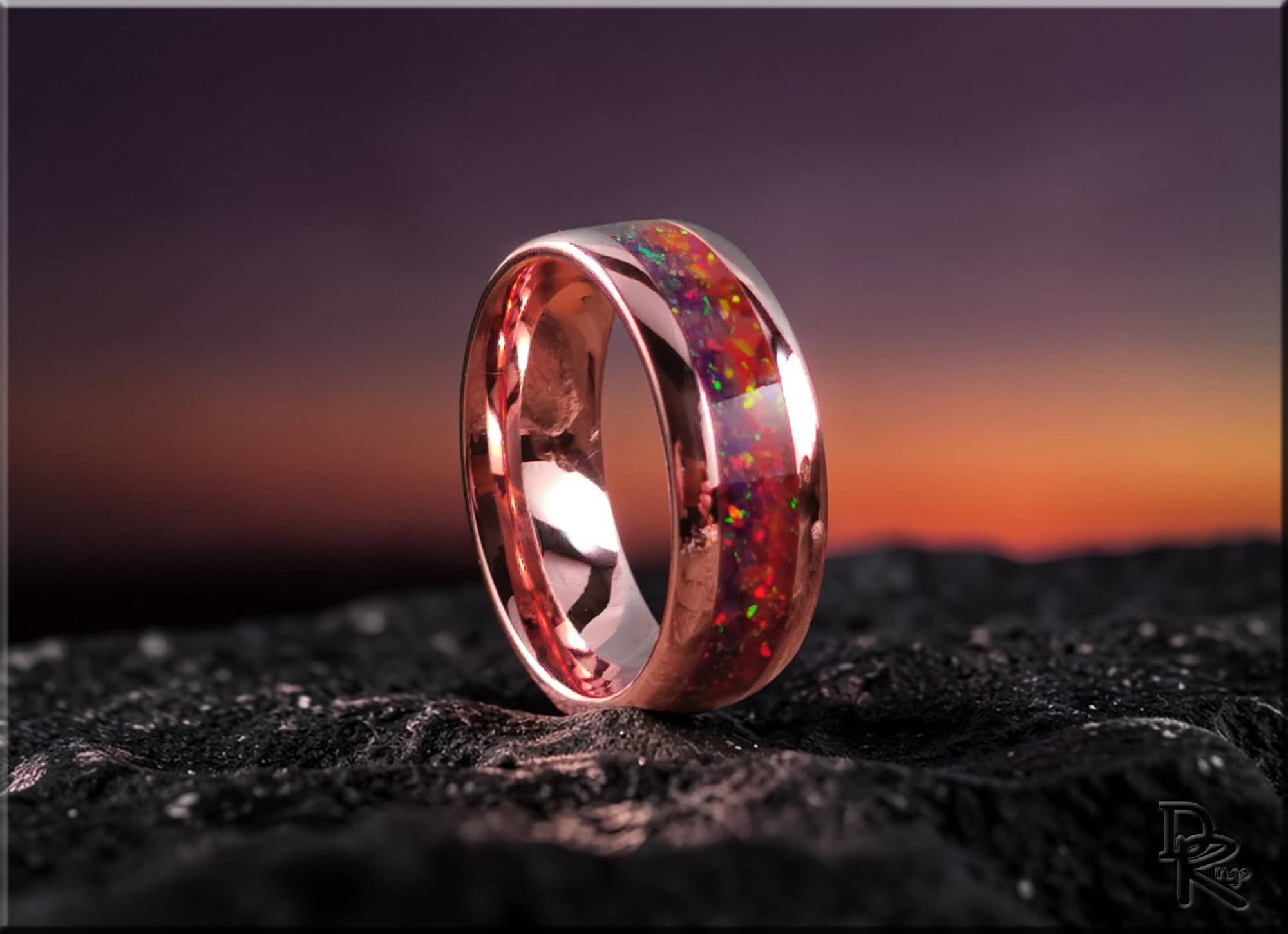 Brushed tellurium copper ring with opal inlaid, showcasing vibrant colors against a sunset background