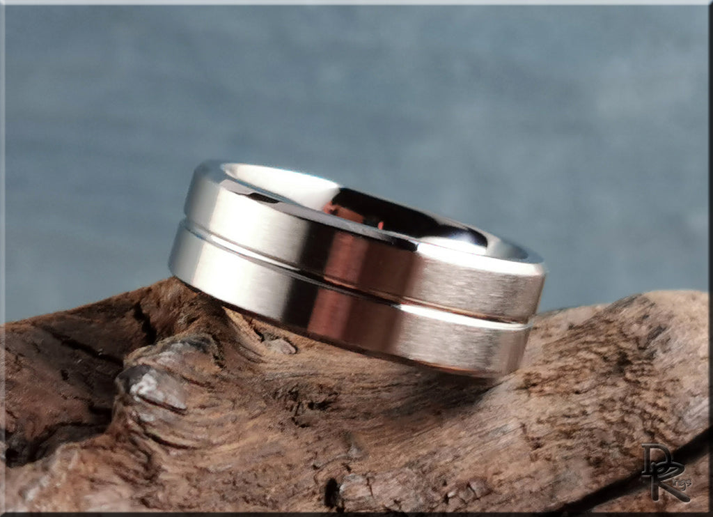 DR Rings polished and brushed cobalt ring resting on textured wood background