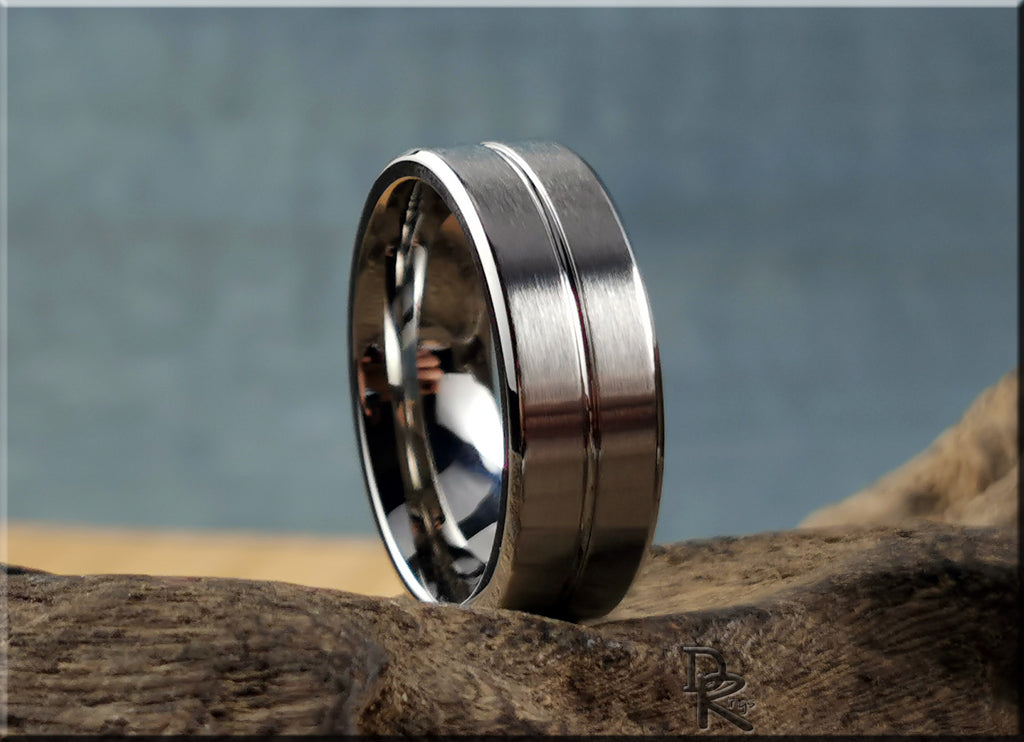 DR Rings polished cobalt ring with brushed center band on natural wood surface