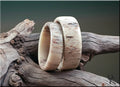 Natural deer antler ring set placed on rustic wood showcasing unique texture and craftsmanship by DR Rings
