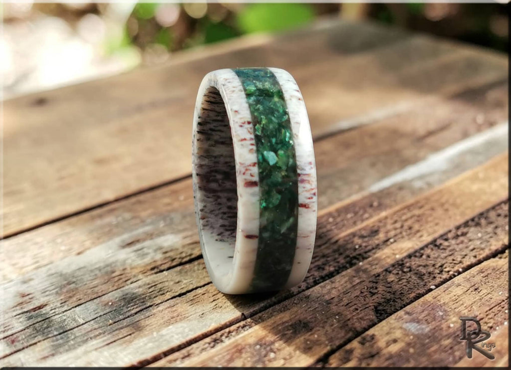 DR Rings antler ring with mica green and white inlay on a wooden surface