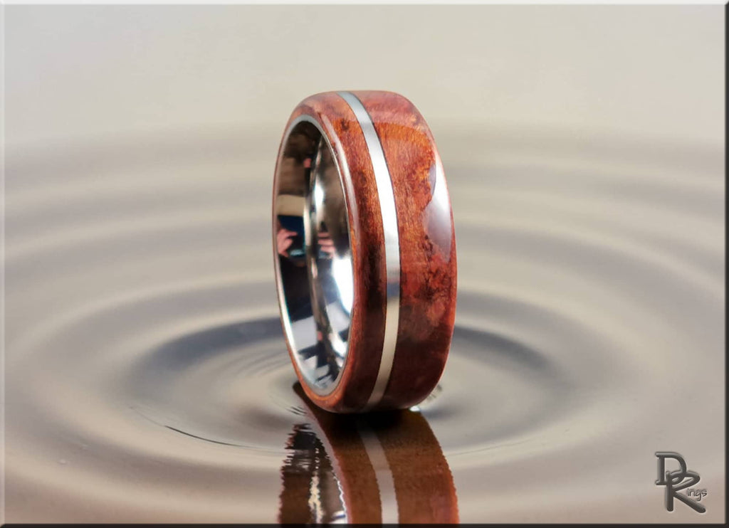 Redwood ring with inlay featuring polished wood and metal band by DR Rings on reflective surface