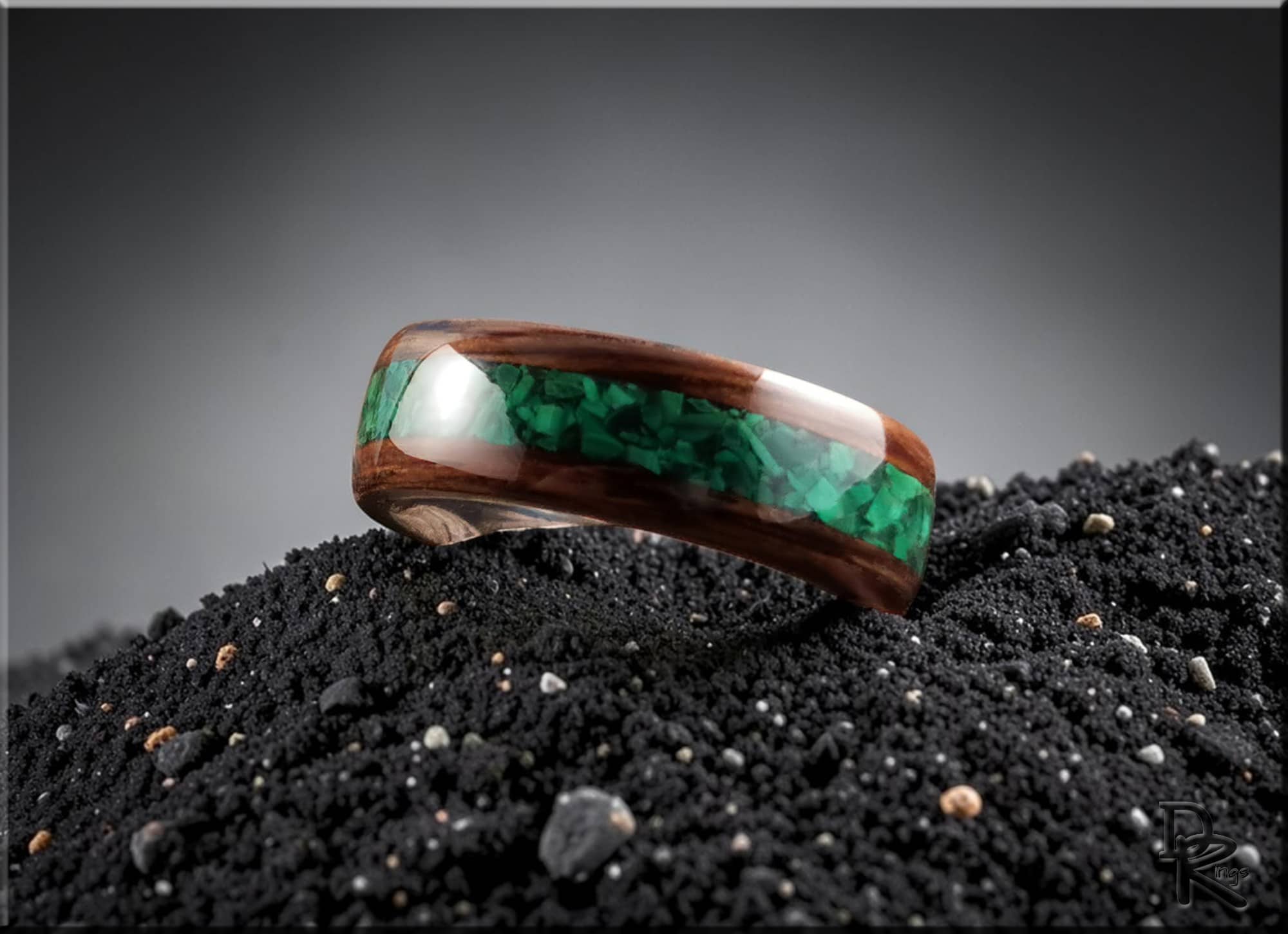 DR Rings wooden band featuring ancient bog oak with malachite inlay on black textured surface