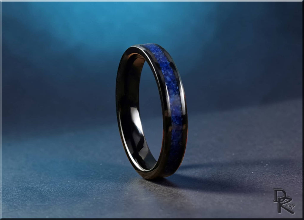 DR Rings black ceramic ring with lapis stone inlay on textured surface with blue background