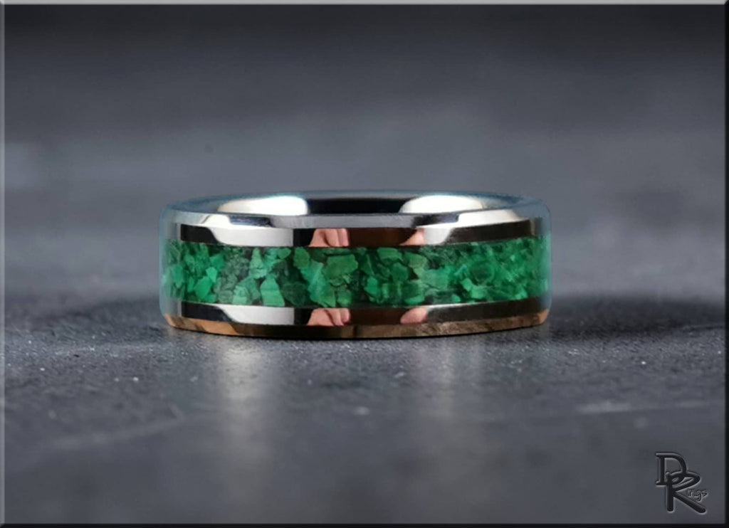 DR Rings tungsten ring with green malachite inlay on gray surface with polished silver edges