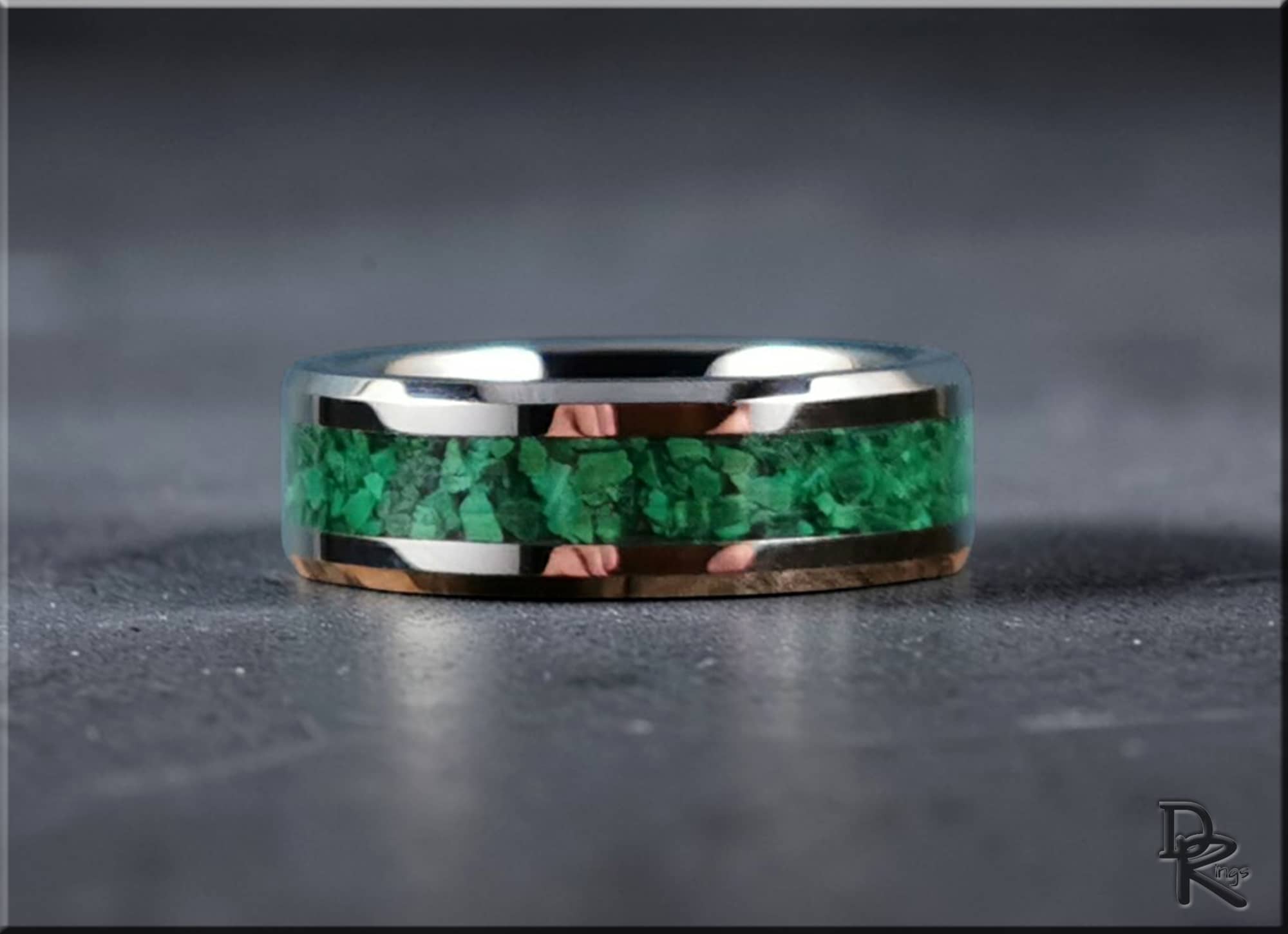 DR Rings tungsten ring with green malachite inlay on gray surface with polished silver edges