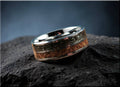 DR Rings tungsten ring with inlays featuring black and wood textured bands on a dark surface