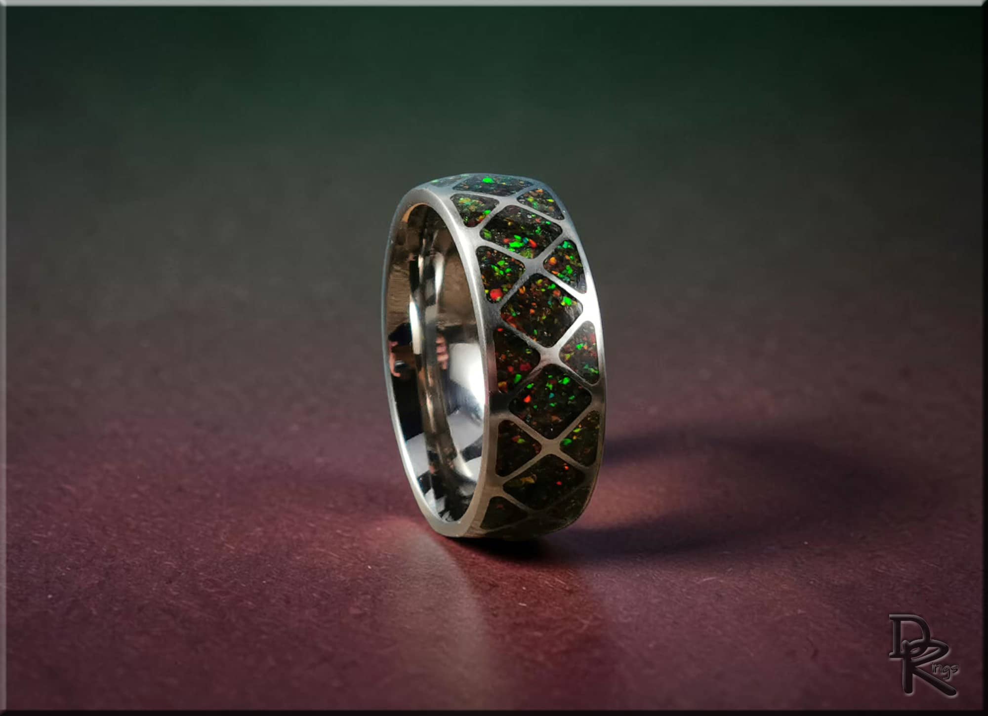 DR Rings titanium ring with opal inlay featuring multicolored green and red opal accents in silver band