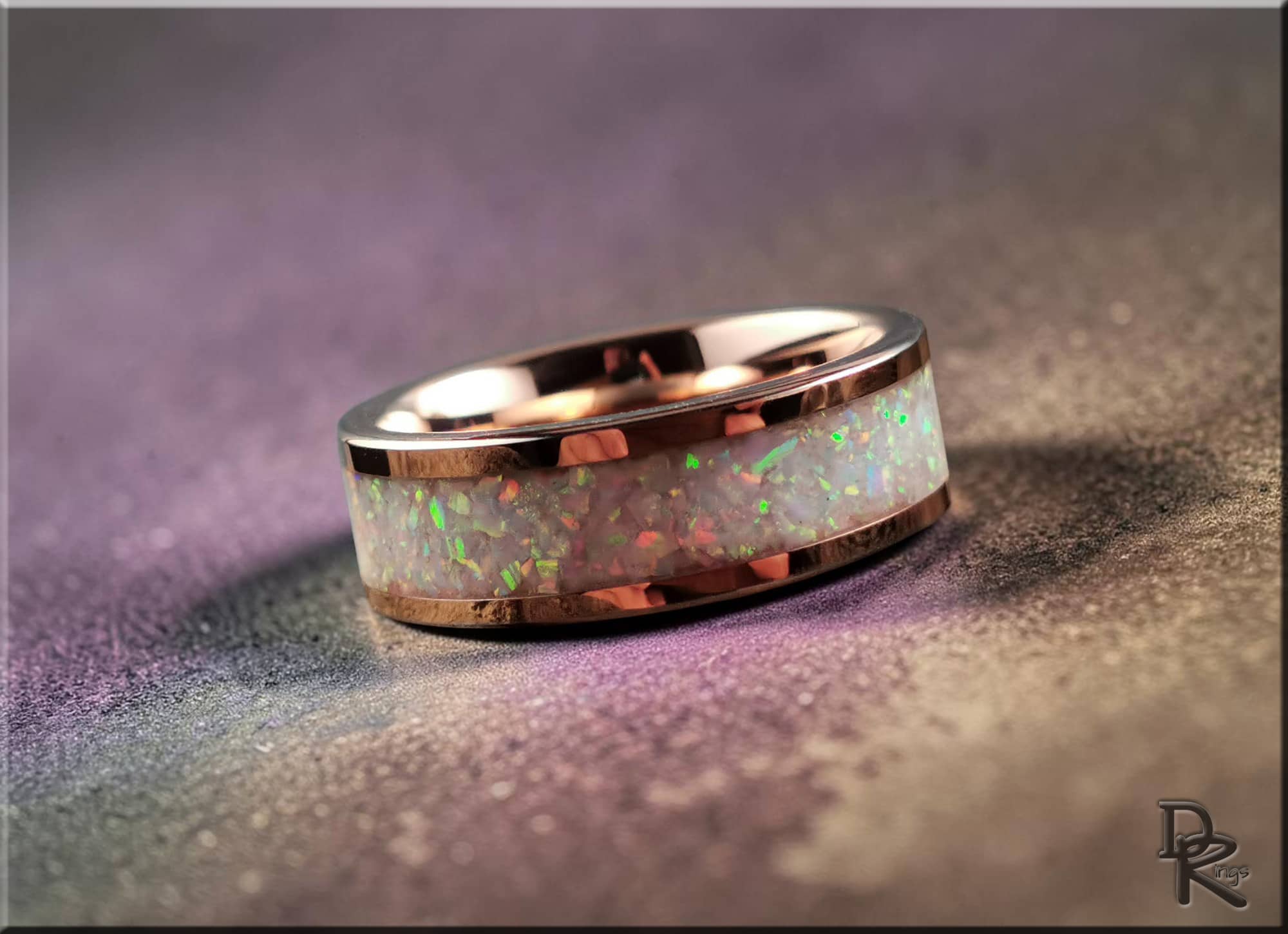 Rose tungsten ring with glow inlay featuring a vibrant opal-like center and polished rose gold edges by DR Rings