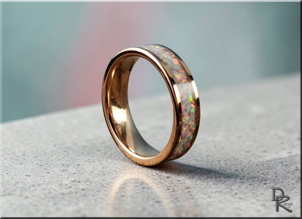 Rose gold tungsten ring with opal inlay featuring a polished finish and vibrant colorful opal stones