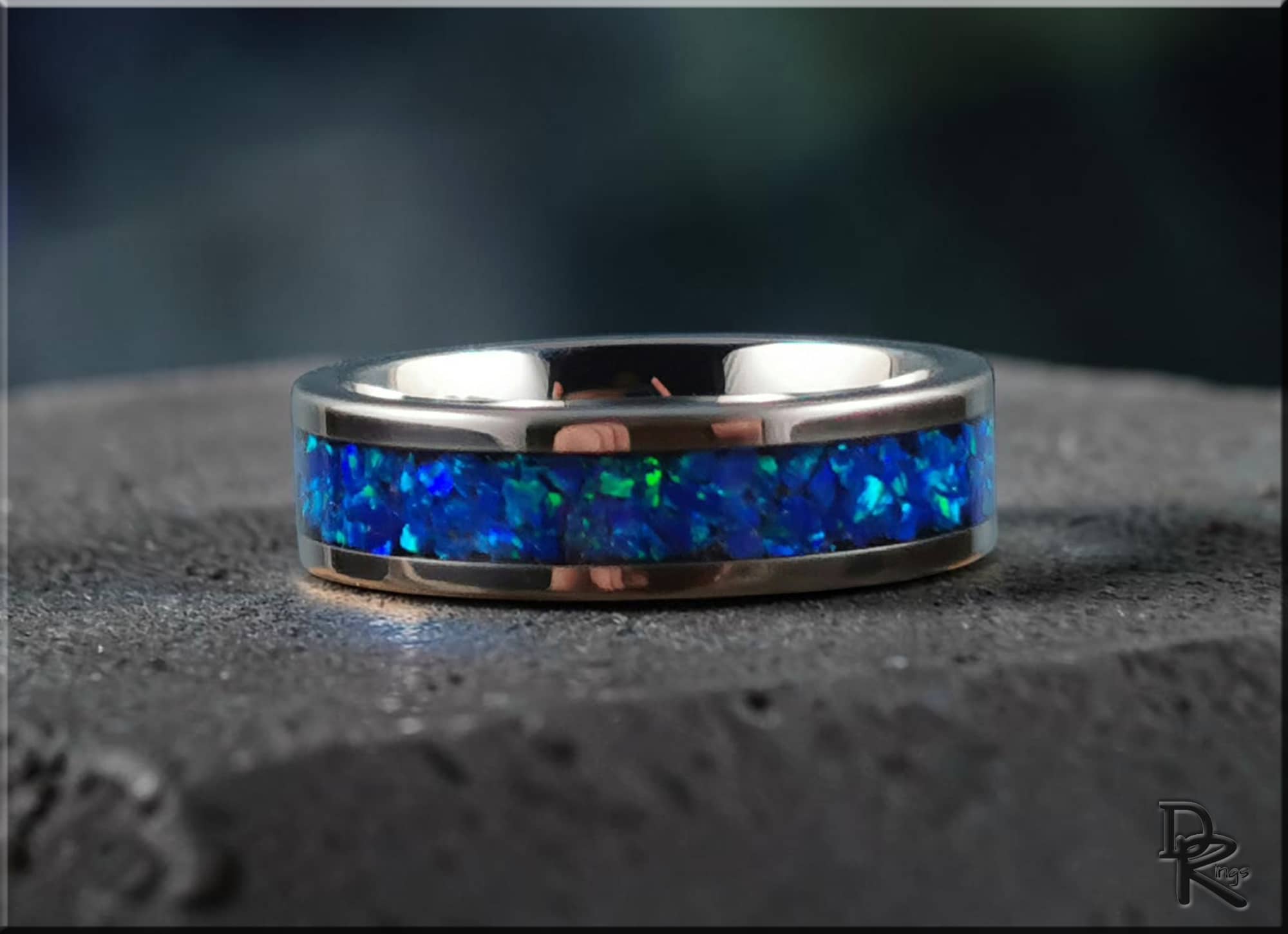 DR Rings super titanium ring with inlay blue opal stone band on dark textured surface