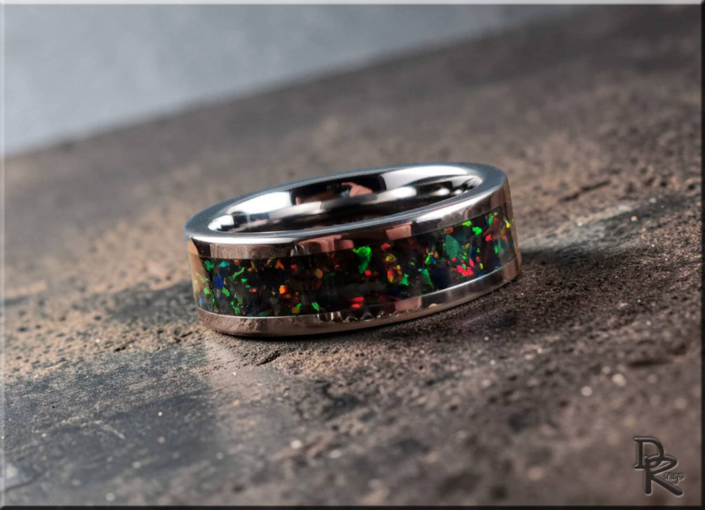 DR Rings super titanium ring with inlay featuring multicolor opal design on a textured surface