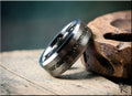 DR Rings tungsten ring with meteorite inlay featuring polished silver finish on wooden surface