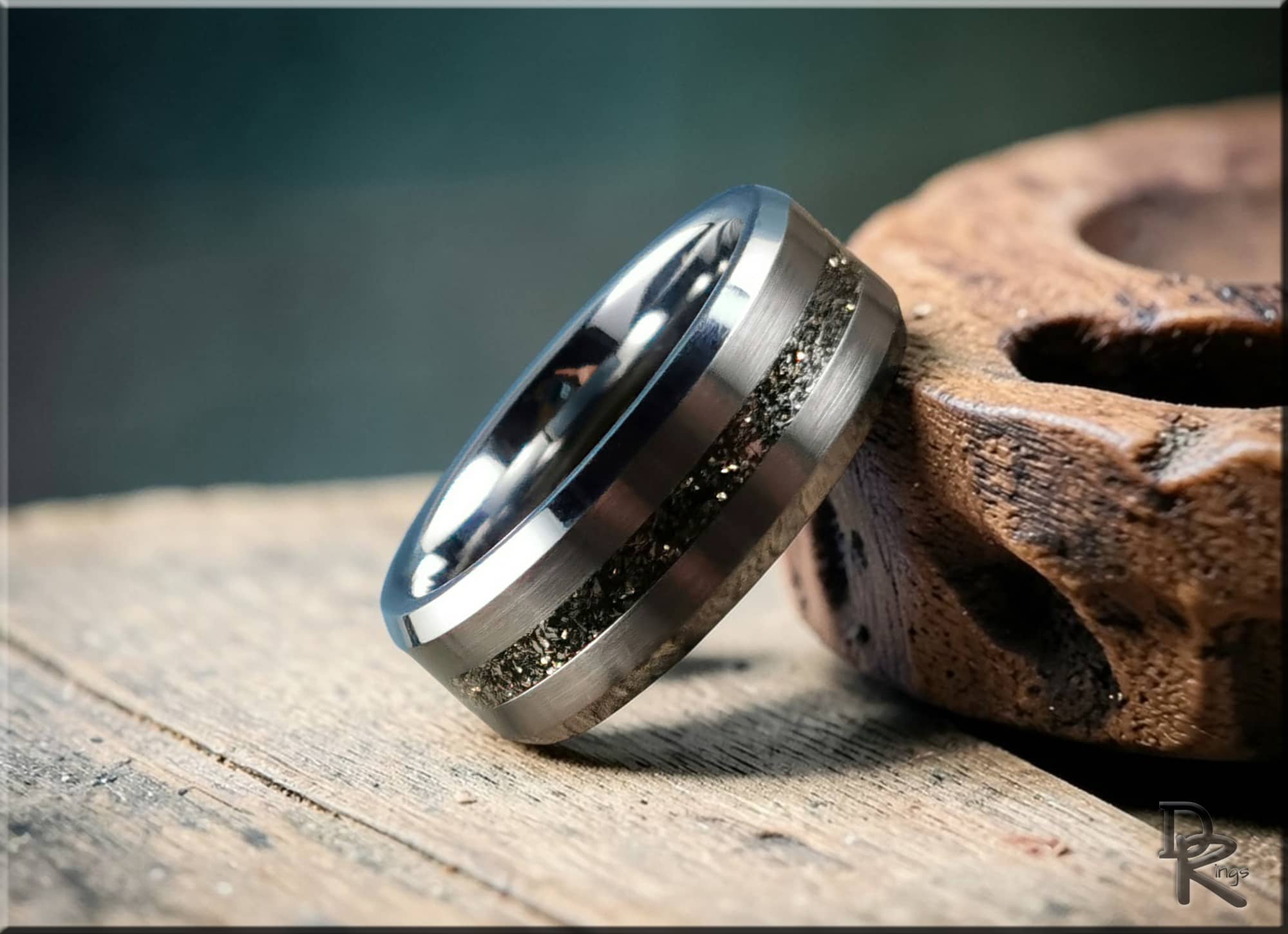 DR Rings tungsten ring with meteorite inlay featuring polished silver finish on wooden surface